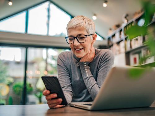 Older woman at home looking at her phone