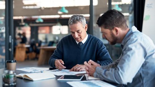 financial sponsors two men looking at finances