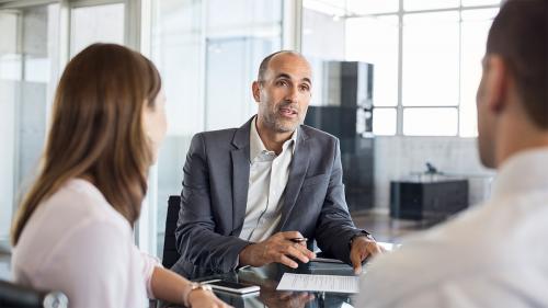 Mortgage Specialty Lending Advisor talking with two clients