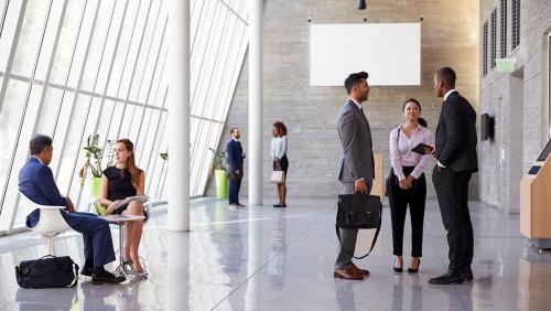 Commercial Liquidity Solutions Colleagues talking in an office lobby