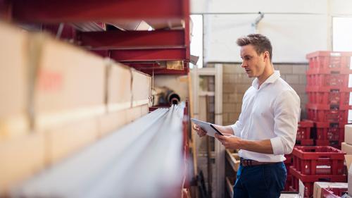 SBA Loans Man in warehouse looking at shelf