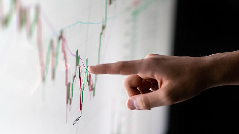 Finger pointing at Candlestick graph