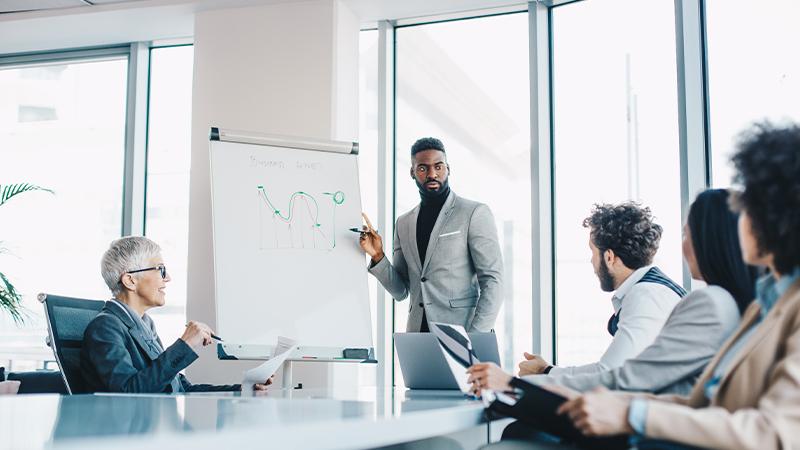 Businessman presenting in front of team