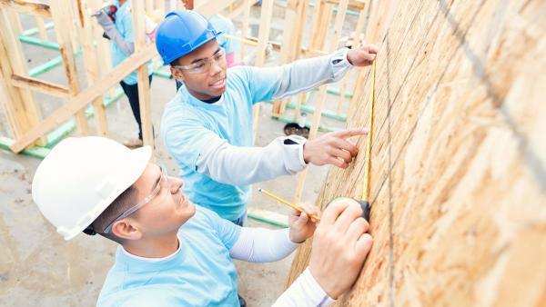 volunteers constructing a home