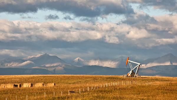 Oil rig with mountains in the background