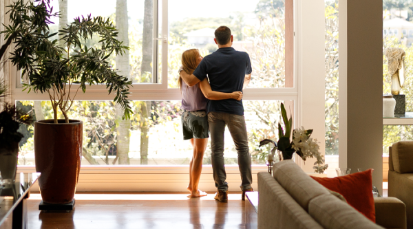 Couple admiring the view from the living room of their house