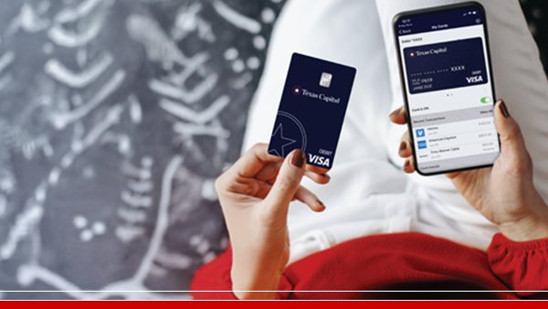 woman in red texas capital debit card and mobile wallet on lap
